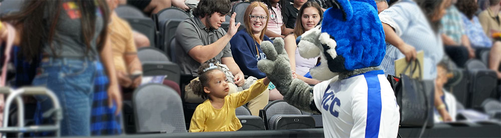 2023 Commencement Recap - MCC Wolf greeting family members and friends of the graduates